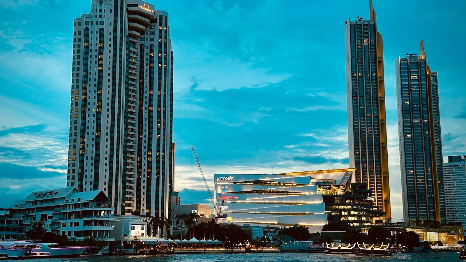 Dazzling nighttime facade and waterfront boardwalk terraces of the iconic ICONSIAM riverside shopping complex