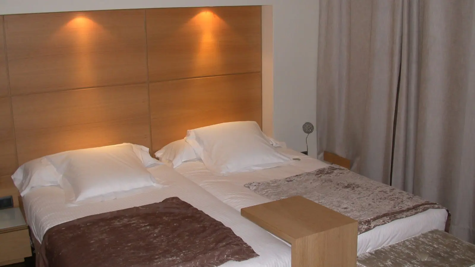Boutique hotel guest room balcony overlooking the elegant octagonal grid streetscape of Eixample