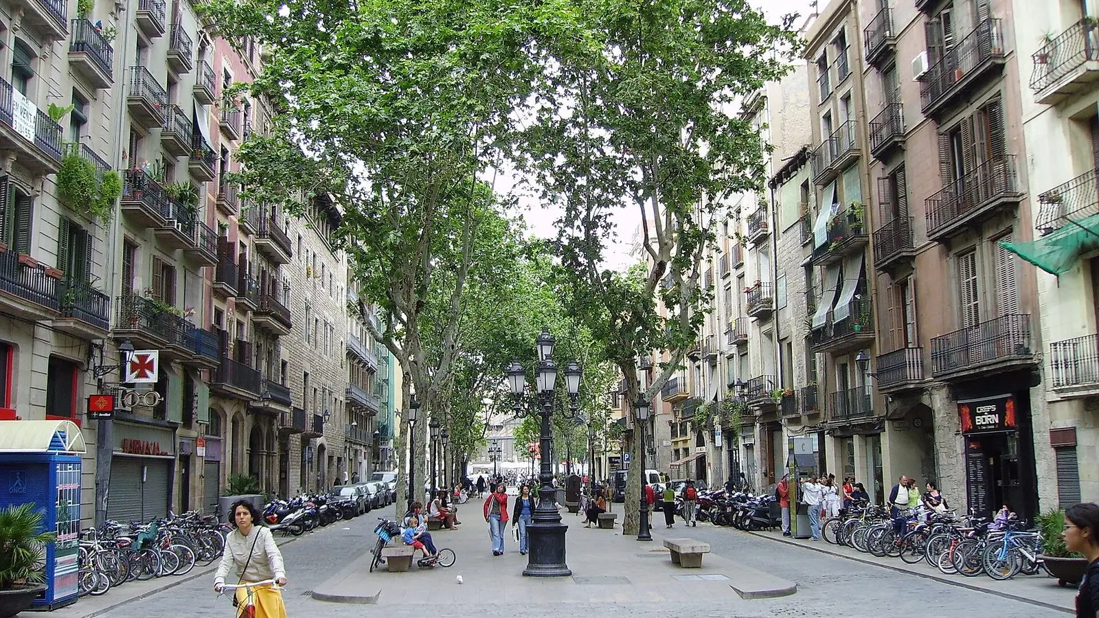 Evening twilight across the historic plaza facing the Basilica of Santa Maria del Mar surrounded by animated diners
