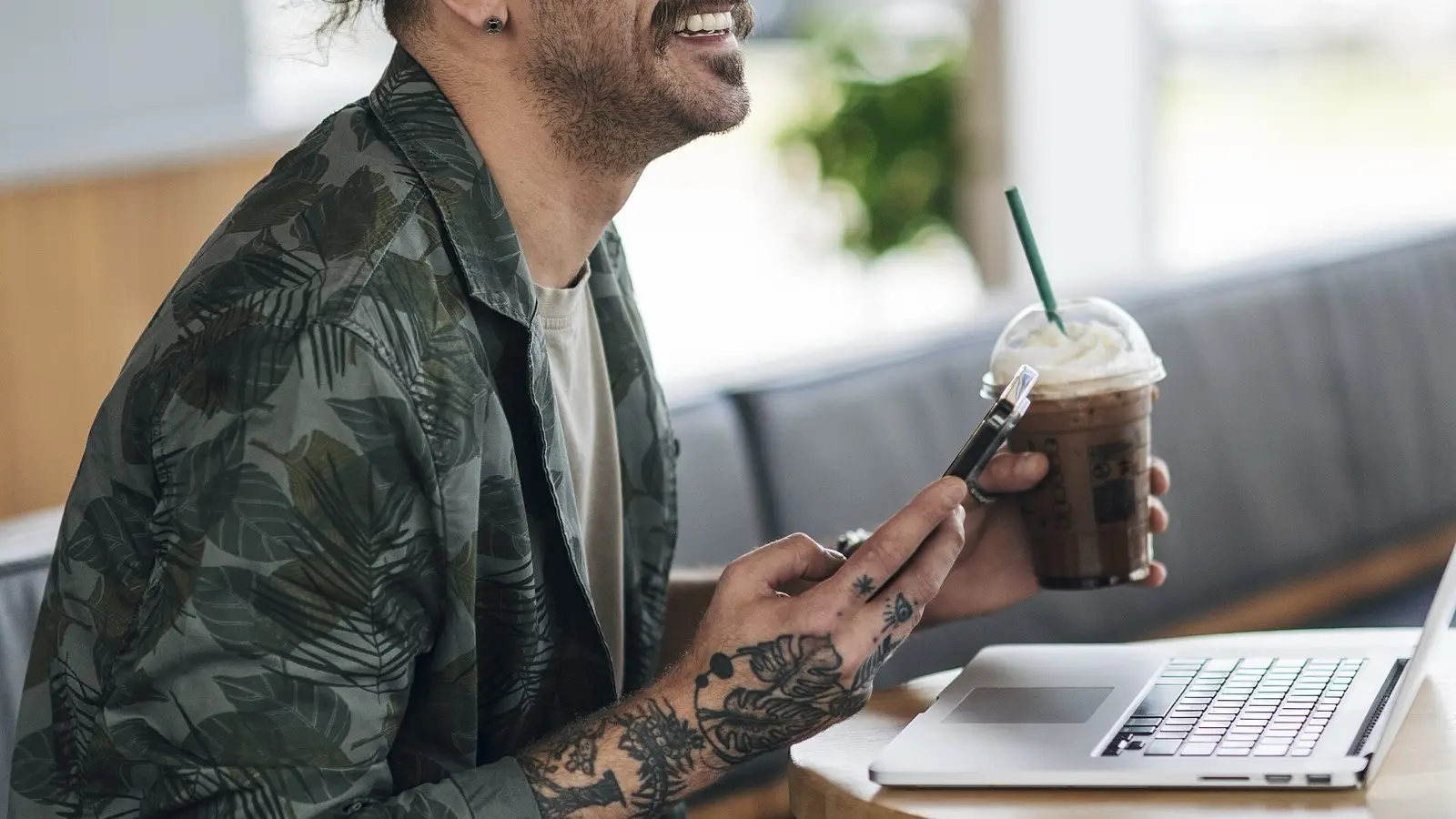 Traveler checking flight fare alerts and booking matrix in a cafe