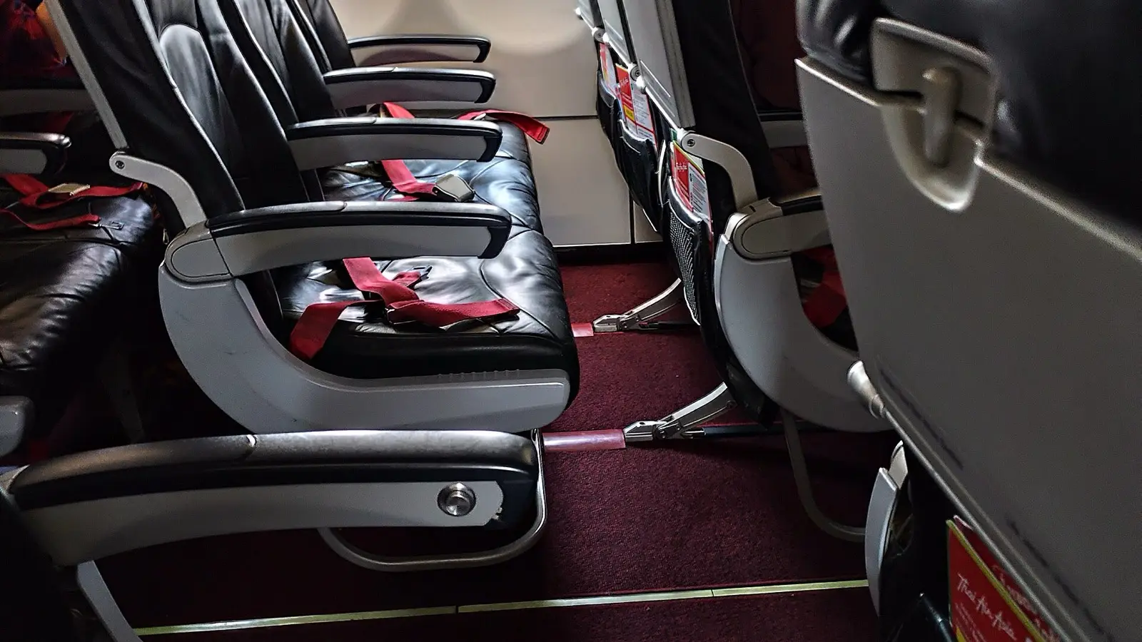 Standard 31-inch pitch economy passenger seat featuring folding tray table and seat pocket