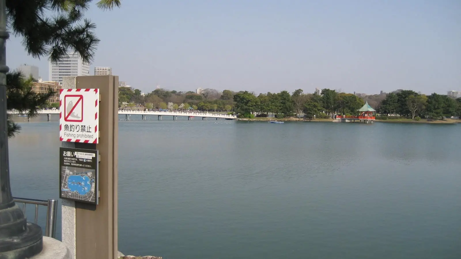 Graceful arched bridges and lakeside pavilions spanning the tranquil waters of Fukuoka Ohori Park