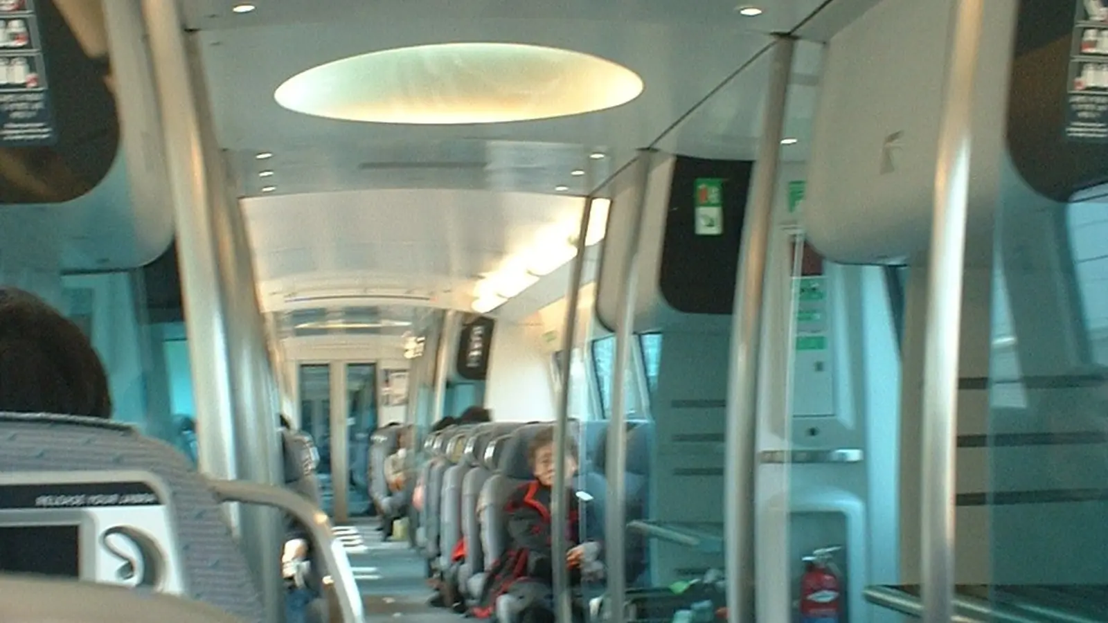 Spacious seating and secure baggage racks inside the high-speed Airport Express train carriage