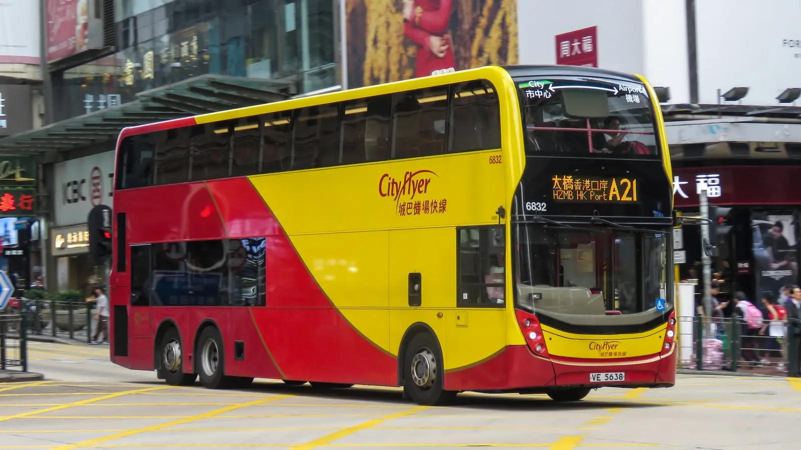 Cityflyer A21 double-decker airport bus cruising down Nathan Road through Kowloon toward Tsim Sha Tsui