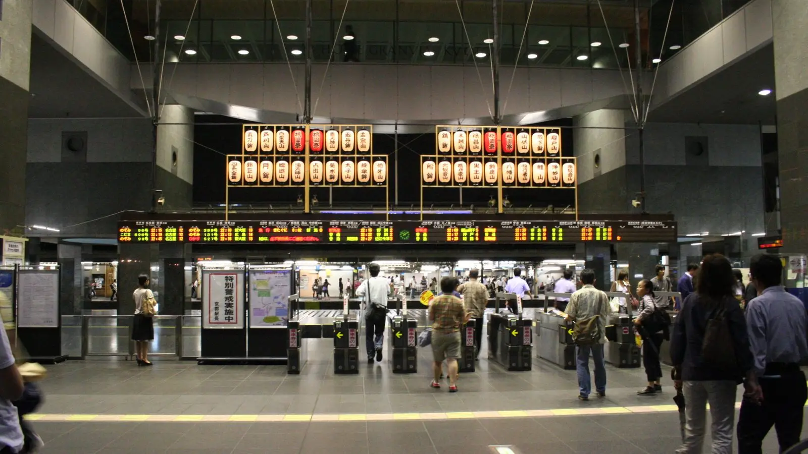 Travelers navigating bustling central concourses at major transit hubs like Kyoto and Tokyo stations