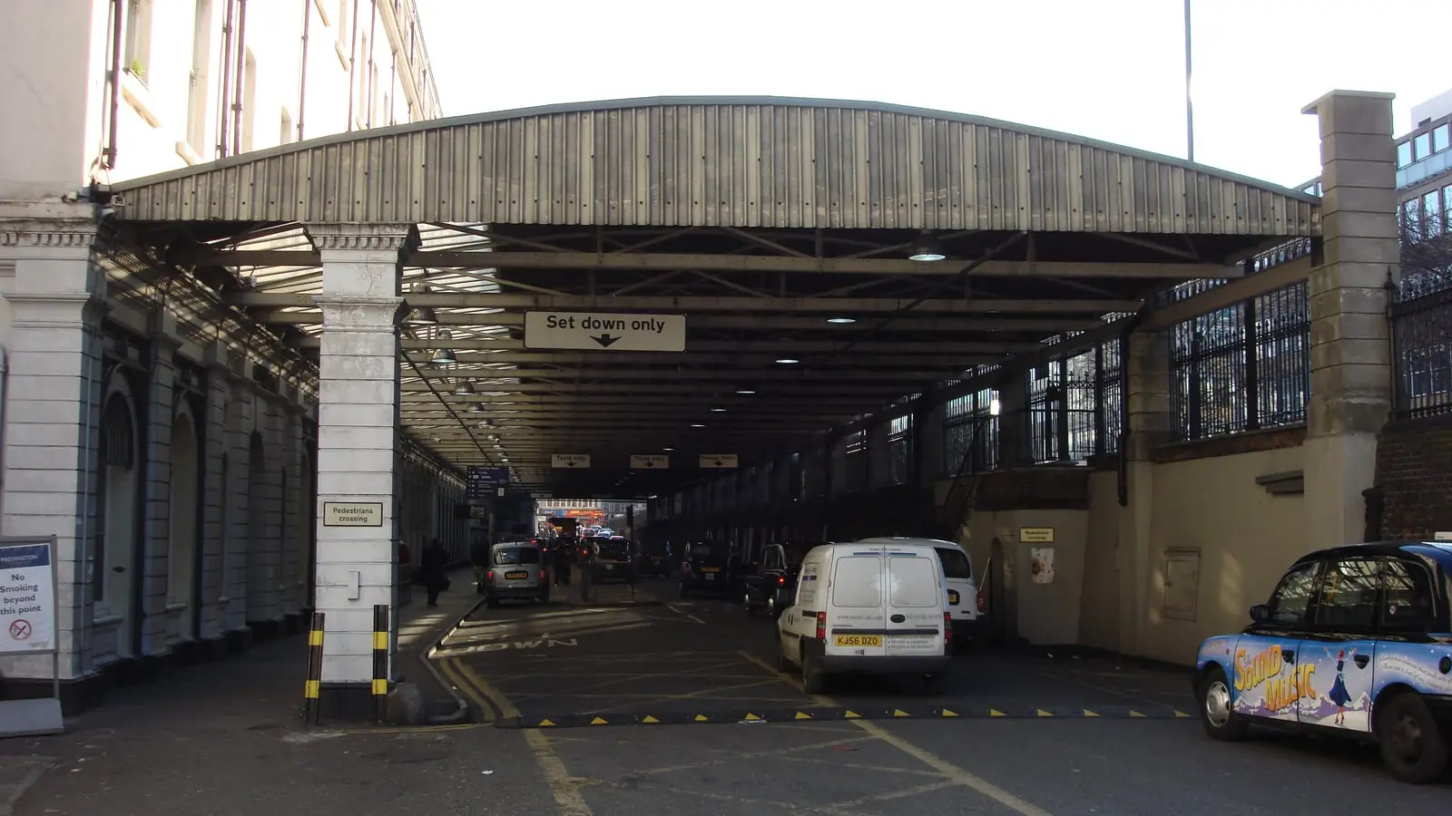Fleet of iconic London Black Cabs queuing at the official Paddington Station taxi rank