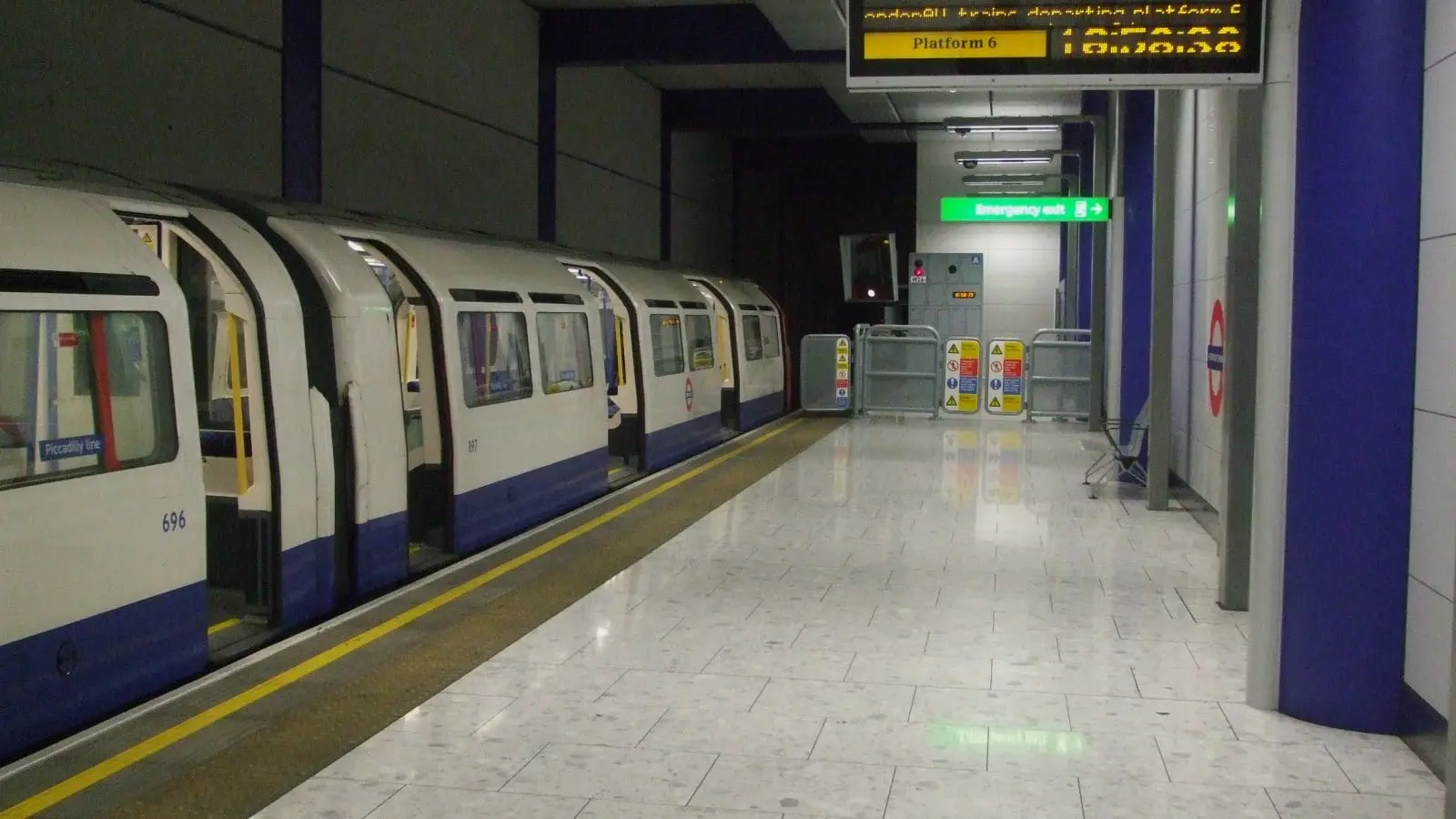 London Underground Piccadilly line tube train at Heathrow Terminal 5 subterranean platform