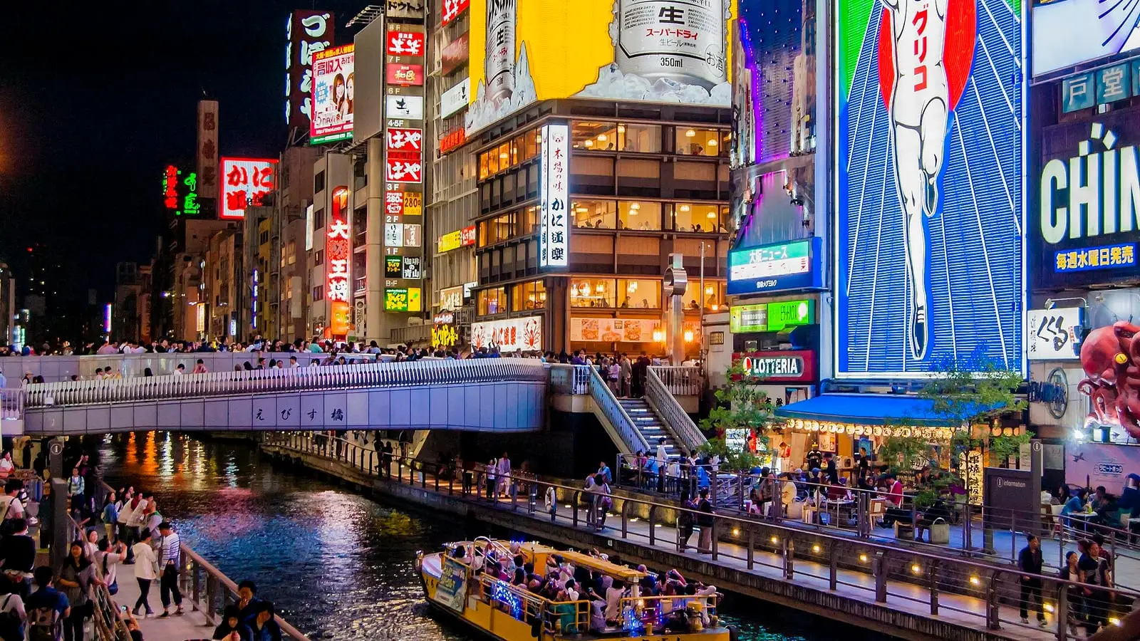 Vibrant neon reflections and culinary energy along Osaka's Dotonbori canal