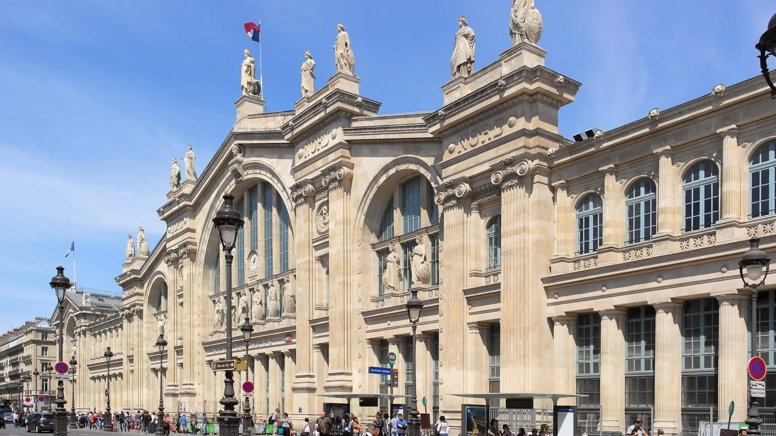 Historic stone facade of Gare du Nord, the primary northern railway gateway into central Paris