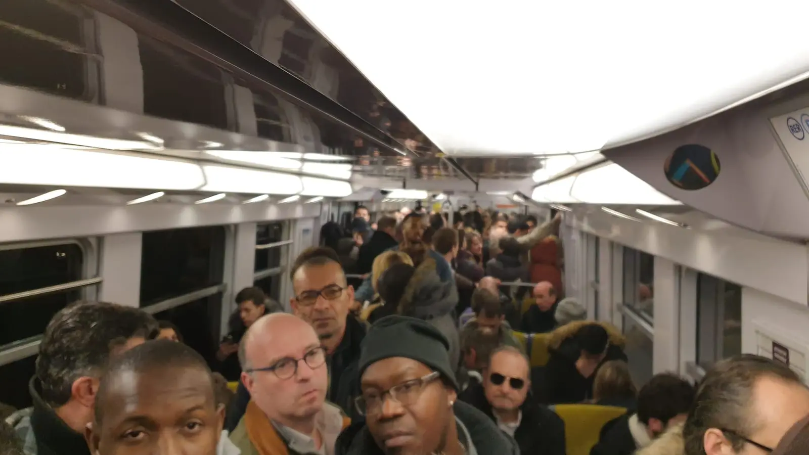 Passenger seating layout and luggage area inside an inbound Paris RER B train carriage