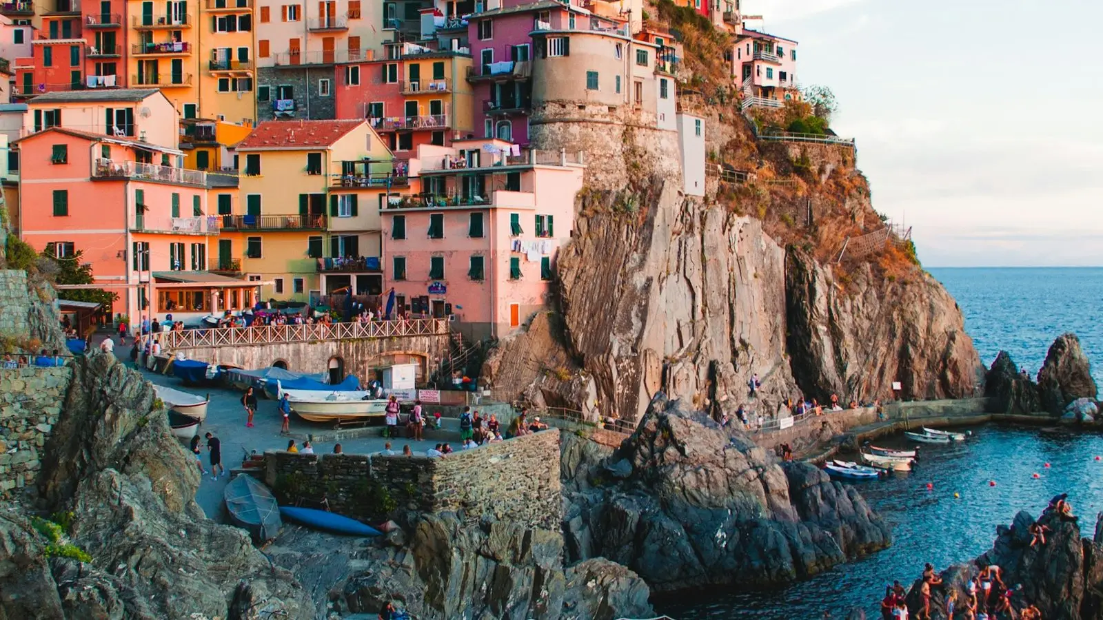 Vivid magenta, bright turquoise, and sunny yellow facades flanking picturesque canals lined with wooden skiffs